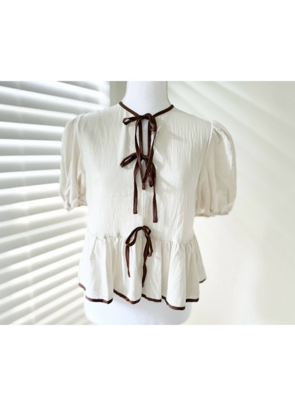 Cream Peplum Tie-Front Top with Brown Trim